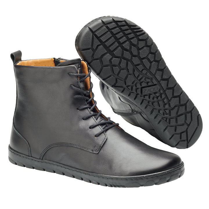 Wir präsentieren die QUINTIC Black-Stiefel von ZAQQ. Diese eleganten Lederstiefel mit Schnürsenkeln und seitlichen Reißverschlüssen sind aus hochwertigem Nappaleder gefertigt. Sie verfügen über strukturierte Gummisohlen, die hervorragenden Halt bieten. Präsentiert in einer Anordnung, bei der ein Stiefel aufrecht steht und der andere sein charakteristisches Sohlenmuster hervorhebt.