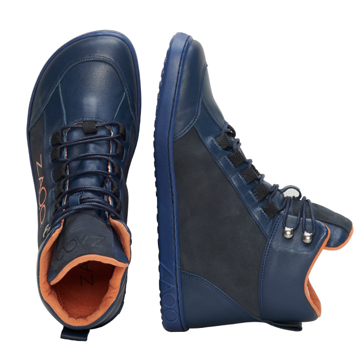 Das Bild zeigt zwei marineblaue ZAQQ WALQER Navy Orange High-Top-Sneaker; einer steht aufrecht, der andere liegt auf der Seite. Diese Schuhe haben ein leuchtend orangefarbenes Futter, ergänzt durch schwarze Schnürsenkel mit Metallösen, und auf der Seite ist der Markenname in Orange aufgedruckt. Sie sind aus hochwertigem Leder gefertigt und mit strukturierten Sohlen für besseren Halt ausgestattet.